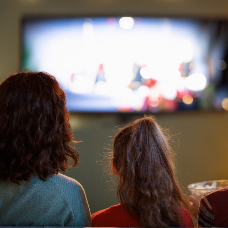 A family watching a movie on a couch
